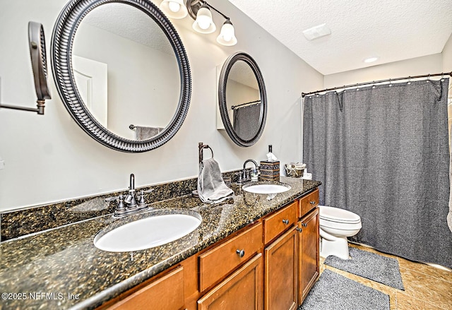 bathroom featuring a sink, a textured ceiling, and toilet