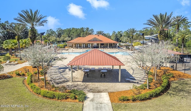 view of home's community featuring a lawn, a patio area, fence, and a pool