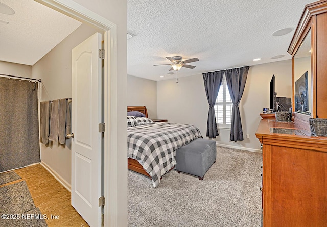 bedroom with baseboards, a ceiling fan, light colored carpet, a textured ceiling, and recessed lighting