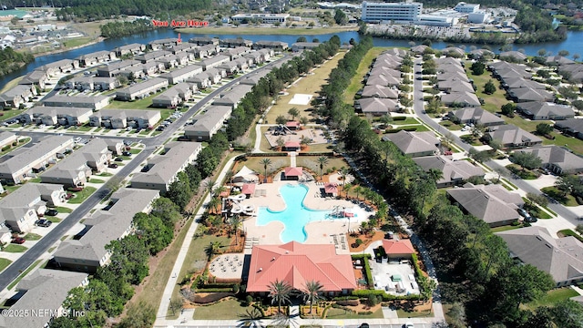 birds eye view of property featuring a water view and a residential view