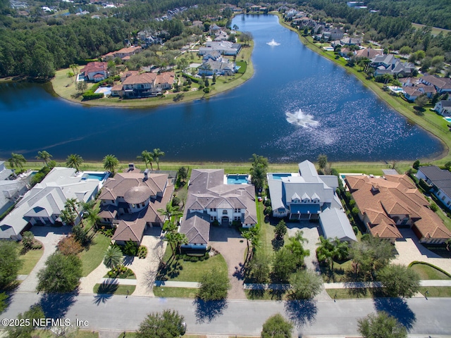 drone / aerial view featuring a residential view and a water view