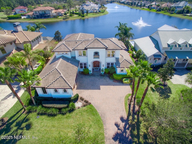 birds eye view of property with a water view and a residential view