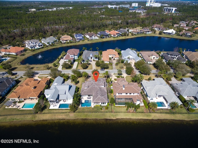 drone / aerial view featuring a residential view and a water view