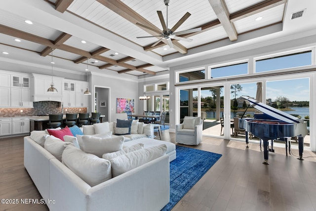 living area with beam ceiling, visible vents, coffered ceiling, and dark wood-style flooring