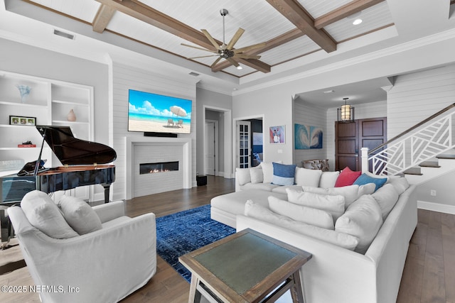 living area with beam ceiling, a fireplace, visible vents, coffered ceiling, and hardwood / wood-style flooring