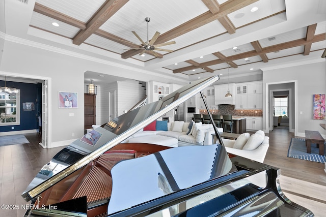 living area featuring baseboards, coffered ceiling, wood finished floors, and beamed ceiling