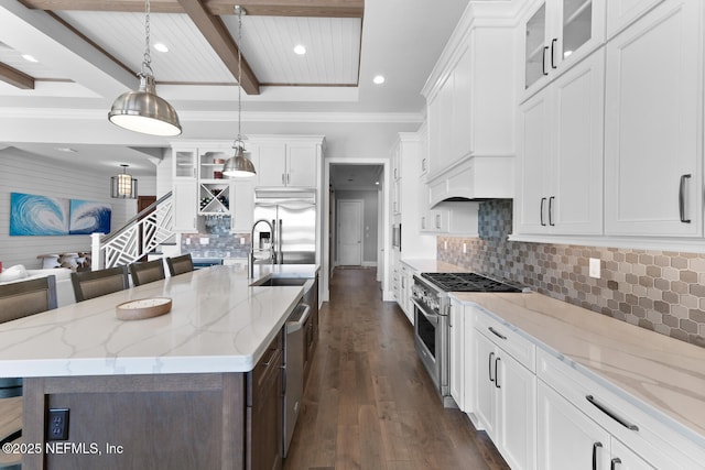 kitchen with premium appliances, dark wood-style flooring, beam ceiling, white cabinets, and a sink