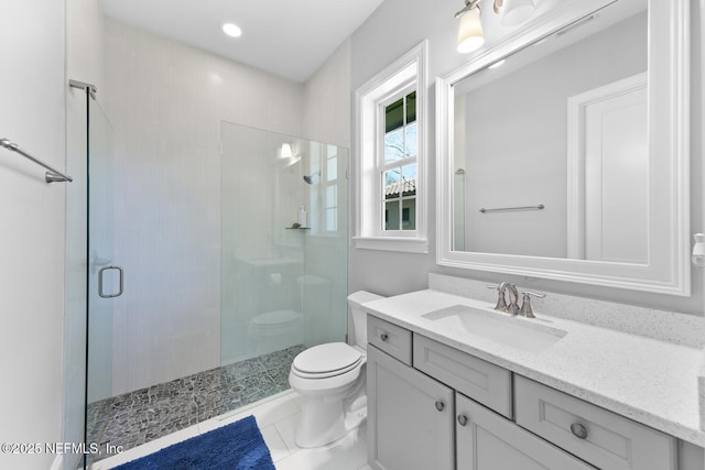 bathroom with vanity, tile patterned flooring, a shower stall, and toilet