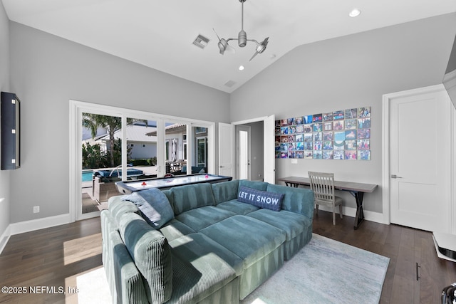 bedroom featuring visible vents, vaulted ceiling, baseboards, and wood finished floors