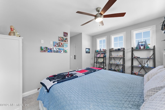 carpeted bedroom with baseboards and a ceiling fan