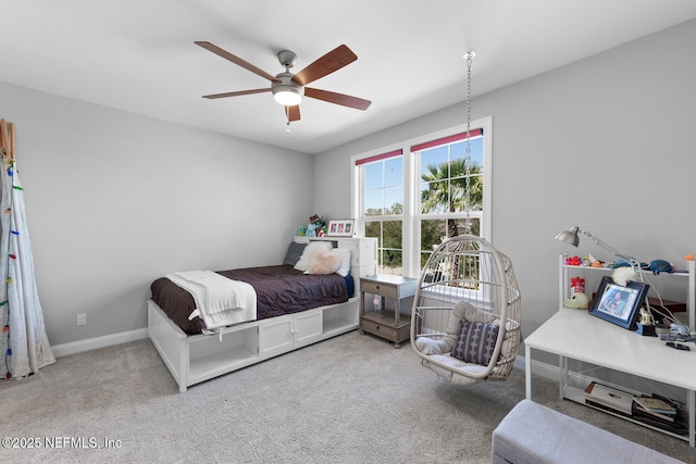 carpeted bedroom with baseboards and a ceiling fan