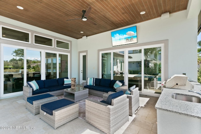 view of patio / terrace featuring ceiling fan, a sink, an outdoor kitchen, and an outdoor hangout area