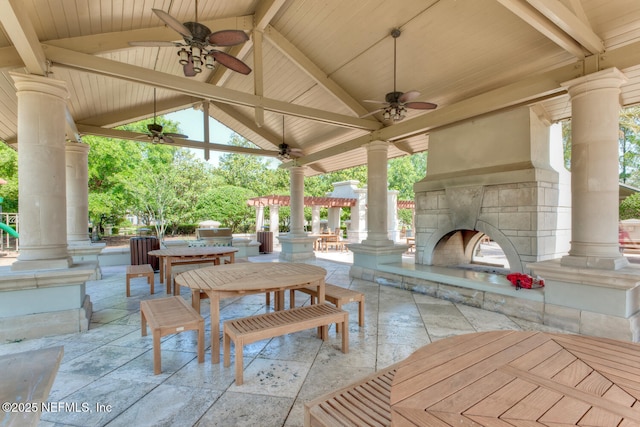 view of patio / terrace featuring outdoor dining area and a fireplace