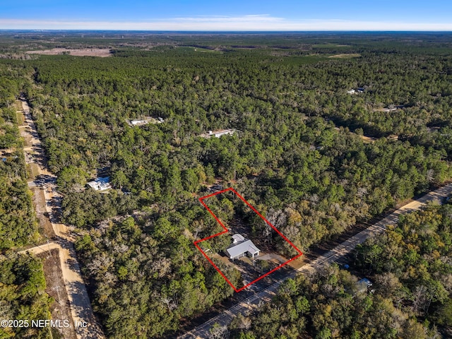 bird's eye view featuring a wooded view