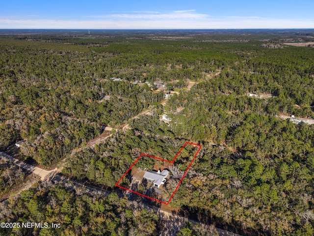 bird's eye view featuring a forest view