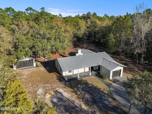 birds eye view of property featuring a wooded view