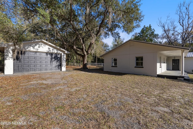 view of side of home with a garage and an outdoor structure