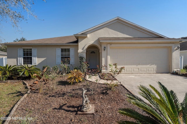 ranch-style house with a garage, driveway, and stucco siding