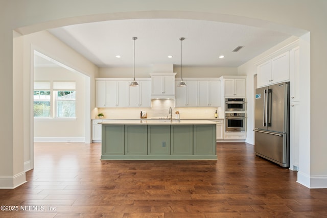 kitchen featuring visible vents, appliances with stainless steel finishes, light countertops, white cabinetry, and backsplash