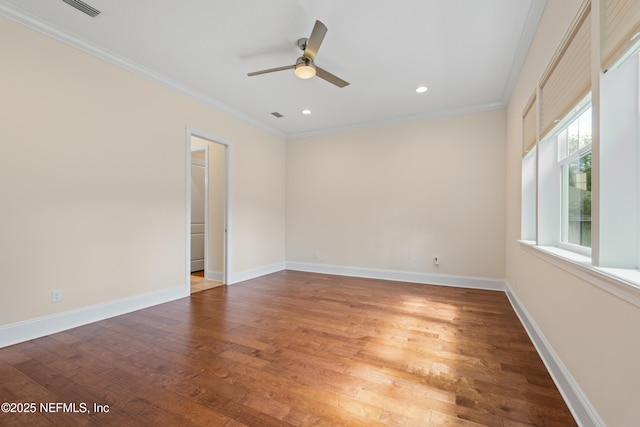 empty room featuring recessed lighting, baseboards, crown molding, and wood finished floors