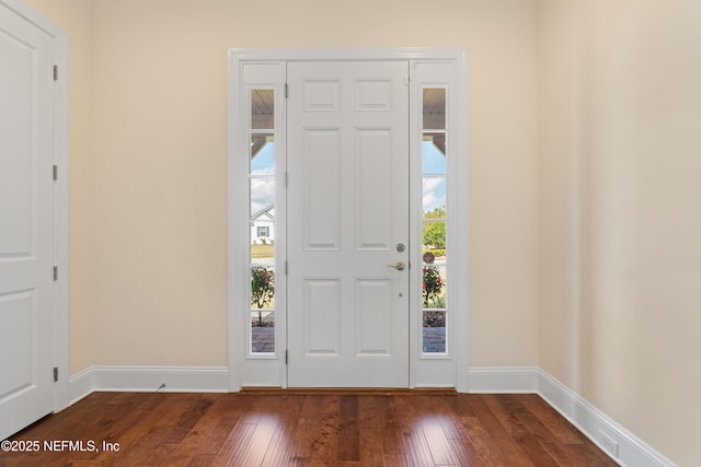 foyer featuring dark wood finished floors and baseboards