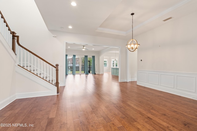 interior space featuring a wainscoted wall, recessed lighting, visible vents, wood finished floors, and stairs