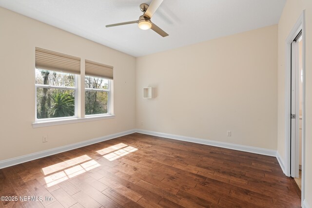 unfurnished bedroom featuring dark wood-type flooring, ceiling fan, and baseboards