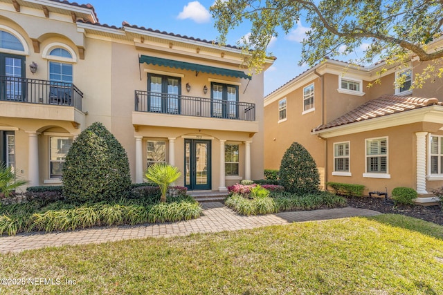 mediterranean / spanish-style house featuring a tiled roof and stucco siding