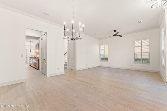 interior space with light wood-style floors, visible vents, crown molding, and stairway