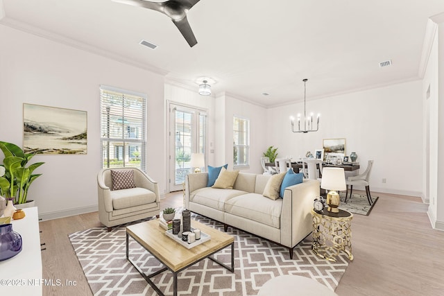 living room featuring ornamental molding, visible vents, light wood-style flooring, and baseboards