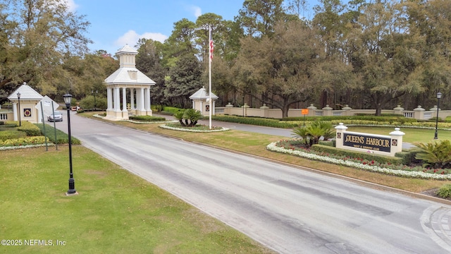 view of road featuring street lighting and curbs