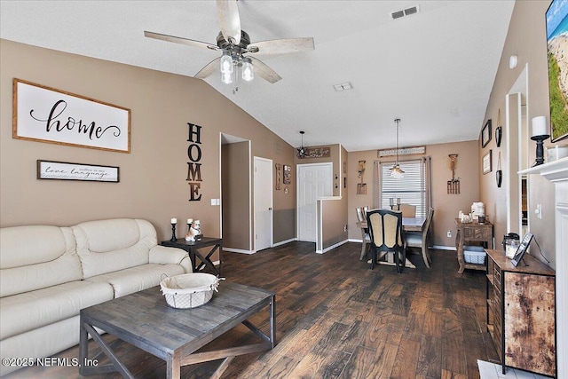 living area with dark wood-style flooring, visible vents, a ceiling fan, vaulted ceiling, and baseboards