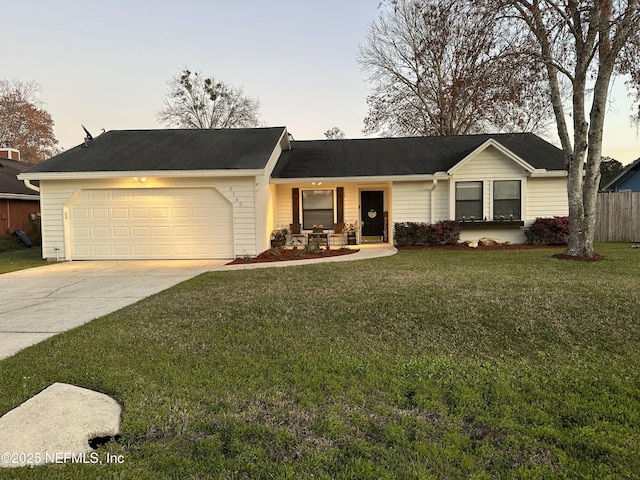 single story home featuring concrete driveway, a yard, an attached garage, and fence