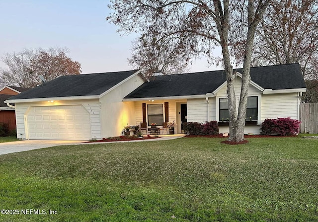 ranch-style house featuring a shingled roof, concrete driveway, an attached garage, fence, and a front lawn