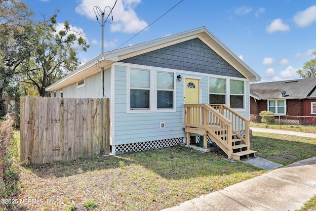 view of front of property with a front yard and fence