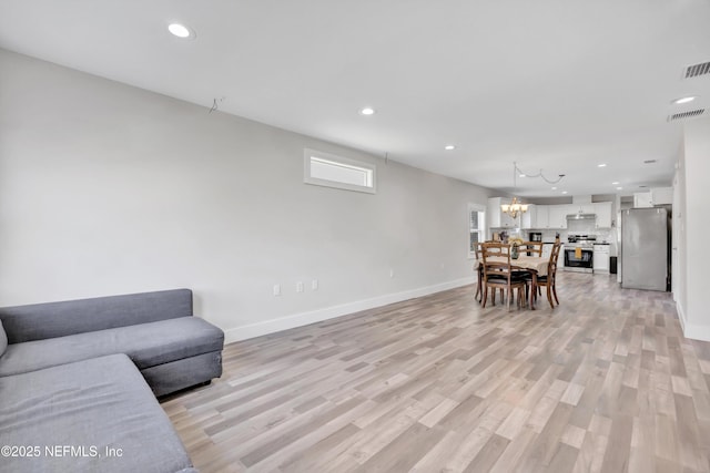 living area with recessed lighting, visible vents, a chandelier, and light wood-type flooring