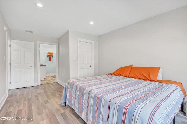 bedroom with recessed lighting, visible vents, baseboards, and light wood-style floors