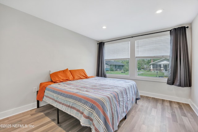 bedroom featuring recessed lighting, baseboards, and wood finished floors