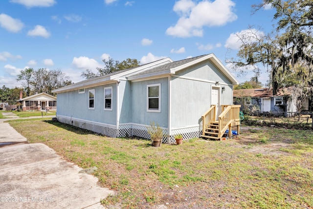 view of home's exterior featuring a yard and fence