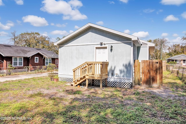 rear view of house with fence