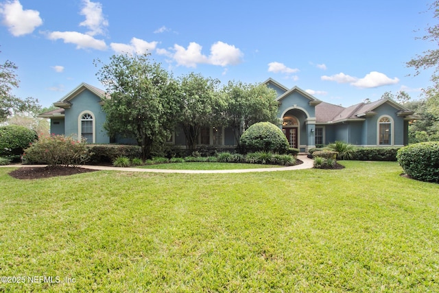 view of front of property featuring a front yard and stucco siding