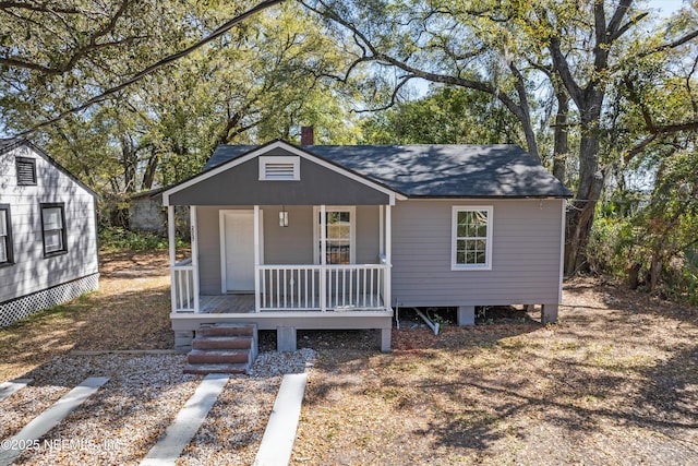 bungalow-style home featuring a porch and a shingled roof