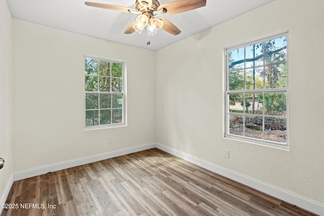 unfurnished room featuring ceiling fan, baseboards, and wood finished floors