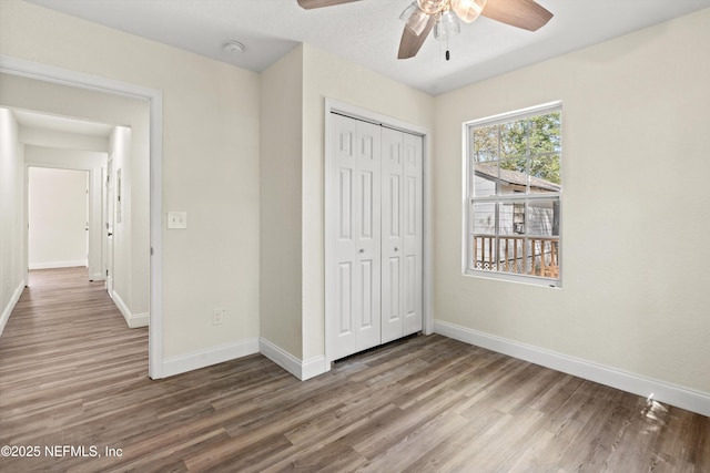unfurnished bedroom featuring baseboards and wood finished floors