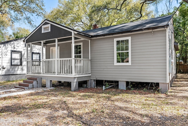 exterior space featuring a porch and a chimney