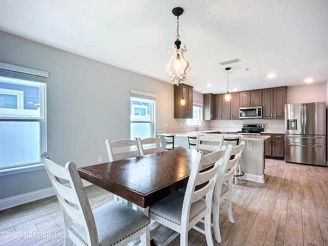 dining space featuring recessed lighting, baseboards, visible vents, and light wood finished floors