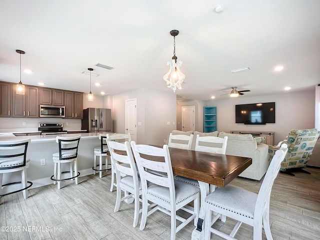 dining room with light wood finished floors, ceiling fan, visible vents, and recessed lighting