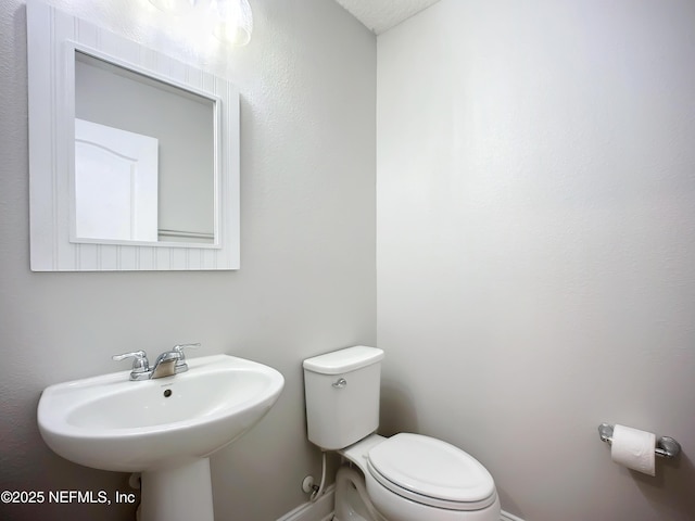 bathroom featuring toilet and a sink