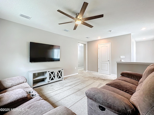 carpeted living area featuring visible vents, ceiling fan, a textured ceiling, and baseboards