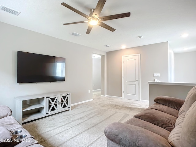 carpeted living room featuring visible vents, ceiling fan, and baseboards